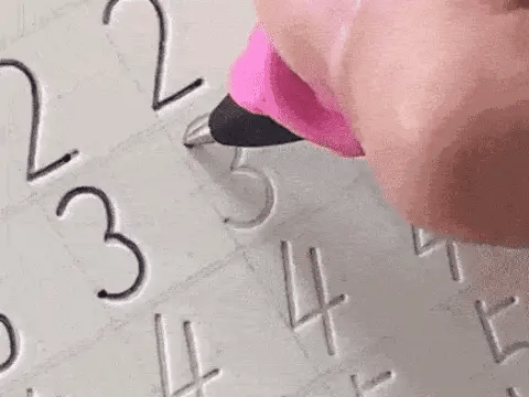 Hand using a tool to engrave numbers onto a metal surface
